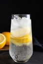 Soda water with lemon slices and ice cubes on black table Royalty Free Stock Photo