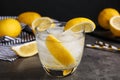 Soda water with lemon slices and ice cubes on grey table Royalty Free Stock Photo