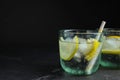 Soda water with lemon slices and ice cubes on grey table. Space for text Royalty Free Stock Photo