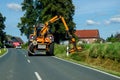 Soest, Germany - August 24, 2021: Maintenance of the edge of a road by a brush cutter tractor Royalty Free Stock Photo