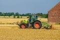 Soest, Germany - July 30, 2019: Claas arion-620 farm tractor with cultivator on the field