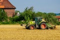 Soest, Germany - July 30, 2019: Claas arion-620 farm tractor with cultivator on the field