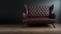 Sofa of black leather standing in center on concrete floor against dark grey wall with copy space. Vintage brown leather sofa with Royalty Free Stock Photo