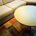 Sofa and coffee table on a colorful carpet Royalty Free Stock Photo