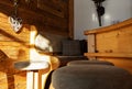 Sofa corner with a wooden wall of an Alpine restaurant, illuminated by the bright morning sun, Austria Royalty Free Stock Photo