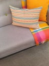 Sofa and cushions in gray and orange tones