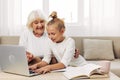 Sofa family hugging child laptop togetherness grandmother bonding selfie granddaughter smiling Royalty Free Stock Photo