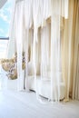 Sofa milky color and transparent curtains. Romantic setting