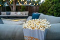 sofa in outdoor setting with popcorn for openair movie