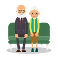 On the sofa sit elderly man and woman. Family portrait of elderly people. Married couple of pensioners at home on couch.