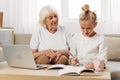 Grandmother child family bonding education selfie smiling video granddaughter laptop sofa togetherness call hugging Royalty Free Stock Photo