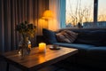 Sofa, stylish table, and a book in a cozy winter evening