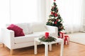 Sofa, table and christmas tree with gifts at home Royalty Free Stock Photo