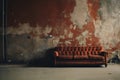 sofa, used and old, fashionable comfortable and stylish, by the cracked wall