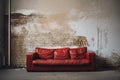 sofa, used and old, fashionable comfortable and stylish, by the cracked wall