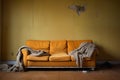 sofa, used and old, fashionable comfortable and stylish, by the cracked wall