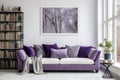 Sofa with violet pillows against window near wall with poster and bookcases, Scandinavian home interior design of modern room