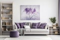 Sofa with violet pillows against window near wall with poster and bookcases, Scandinavian home interior design of modern room