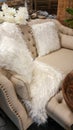 Sofa with white faux fur rug and cushions