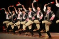 People in traditional folklore costumes perform folk dance bulgarian horo on National folklore fair in the Sofia