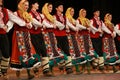 People in traditional folklore costumes perform folk dance bulgarian horo on National folklore fair in the Sofia