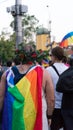 Sofia / Bulgaria - 10 June 2019: Fat guy with Rainbow Flag in the back and Crown of flowers supporting Sofia Pride walking in the