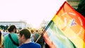 Sofia / Bulgaria - 10 June 2019: Guy holding big Rainbow Flag in the Sofia Pride March walking in the street