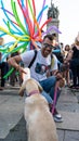 Sofia, Bulgaria / June 10 2019: Tan guy in the middle of the festival giving water to a puppy, Labrador Retriever. Pride festival Royalty Free Stock Photo