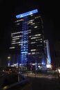 Night closeup on blue illuminated UBB Headquarter Millennium Center skyscraper building