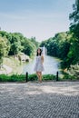 Sofia Park, Ukraine. Brunette girl in a landscaped park. Girl on the background of a fountain in a beautiful park. Fountain with a