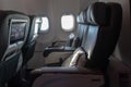 Soft armchairs in the right business class aircraft. Open porthole in a business class plane.