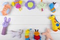 Soft baby toys on wooden background with copy space