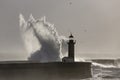 Soft backlit sea wave splash over old lighthouse Royalty Free Stock Photo