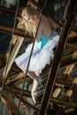 Soft ballerina is sitting on an old rusty ladder Royalty Free Stock Photo