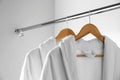 Soft bathrobes hanging on rack in closet Royalty Free Stock Photo