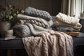 soft blankets and cushions in hand-knitted textures on a wooden bench