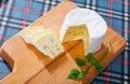 Soft blue cheese on wooden board with parsley Royalty Free Stock Photo