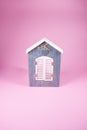 Soft blue handmade wooden window with closed shutters on pink background Royalty Free Stock Photo