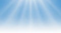 Soft blue sky background features radiant sunbeams spreading across the upper Royalty Free Stock Photo