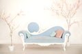 A soft blue sofa with artificial flowering trees in a white living room. Classic style sofa in the house. Antique wooden sofa armc Royalty Free Stock Photo