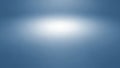 Soft blue studio background with a bright white spotlight in the center creating a subtle gradient effect Royalty Free Stock Photo