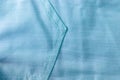 Soft blue, turquoise cotton fabric texture background with stitched diagonal stripes and with pocket