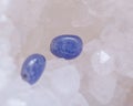 Soft blue violet TANZANITE extra quality beads from Tanzania on crystalline druzy center of quartz geode. Royalty Free Stock Photo