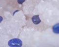 Soft blue violet TANZANITE extra quality beads from Tanzania on crystalline druzy center of quartz geode. Royalty Free Stock Photo