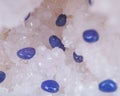 Soft blue violet TANZANITE extra quality beads from Tanzania on crystalline druzy center of quartz geode. Royalty Free Stock Photo