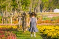 Soft blur of back of little girl run into flower garden with morning light