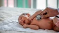 Soft blur of the doctor hands use stethoscope to check newborn baby health and take care him or cure the disease or disorder