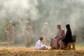 Soft blur of muslim family look to group of soldier come from the jungle during the battle near the village Royalty Free Stock Photo