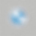 A soft, blurred circular patch of light blue is centered on a textured, light gray background Royalty Free Stock Photo