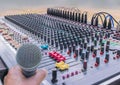 Soft blurred and soft focus of microphone with controls of sound mixing console,mixer sound. Royalty Free Stock Photo